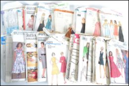 A collection of mid century - 20th century Sewing patterns in the original packaging with