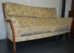A contemporary Ercol three seater sofa / settee having a chintzy fabric upholstery  ( Fabric No E015