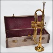 A cased vintage 20th century trumpet in the case,