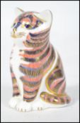 A Crown Derby figurine of a cat being marked to th