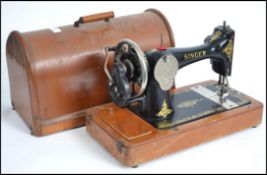A cased vintage manual singer sewing machine toget
