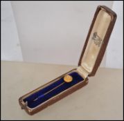 A 18ct gold marked stick pin having a central diam