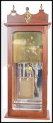 An unusual large wall clock set within a mahogany