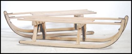 A pair of retro 20th century children's wooden sla