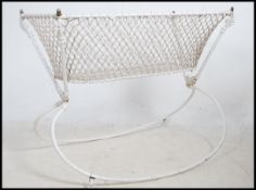 A 19th century cast iron childs rocking crib havin