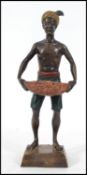 A cold painted bronze of a Blackamoor in an uprigh