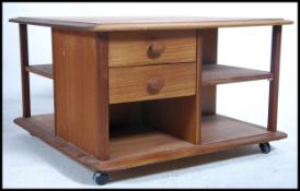 An original retro teak wood Pandora coffee table with drawers and storage recesses having ball