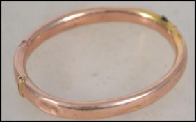 A hallmarked 9ct gold slave bangle bracelet having