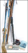 A collection of vintage fishing equipment to include sea fishing rod, wooden fishing rods in