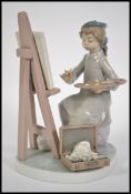 A Lladro seated figurine of a girl painting / arti