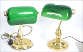 A good pair of brass and green glass desk top bank