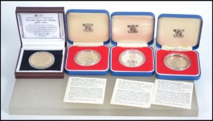 A collection of four commemorative silver proof co