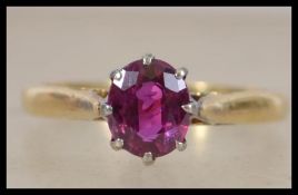 An 18ct gold ring set with a single claw mounted o