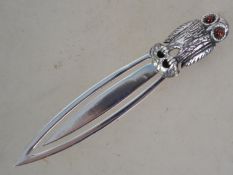 A large silver book mark in the form of an owl ( s