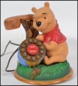 A novelty retro Winnie The Pooh telephone