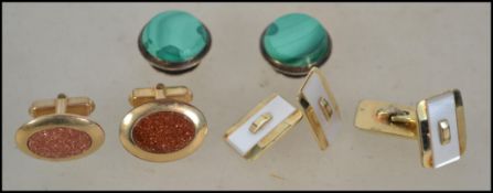 A pair of vintage malachite set cuff studs togethe