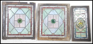 A collection of stained glass window panels dating