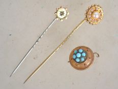 A 9ct gold and seed pearl adorned stick pin togeth