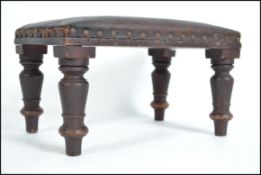 A Victorian Arts & Crafts leather footstool having