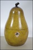 An unusual Georgian style tea caddy in the form of a pear with hinged centre and key escutcheon