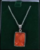 A ladies silver and apple coral pendant and neckla