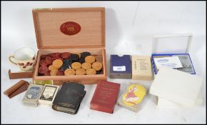 A collection of vintage 20th century playing cards together with draughts, 19th century miniature