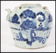 A Chinese blue and white Kang-xi period ceramic teapot decorated with trees, boats, waves and