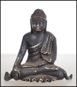 A believed 18th century, possibly earlier silver cast miniature figurine of a buddha / deity in