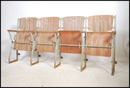 A set of four vintage 20th century cinema chairs. Set on a metal tubular frame having wooden flip up