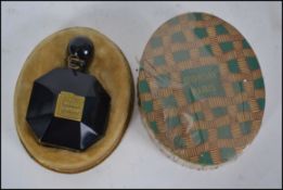 An early 20th century black faceted glass Le Dandy