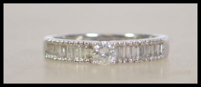 An 18ct white gold diamond ring, the central stone