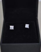 A pair of ladies silver and cz adorned earrings co