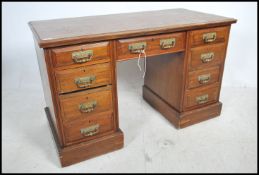 An Edwardian oak twin pedestal desk raised on pede