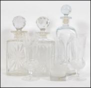 A collection of three glass decanters and stoppers
