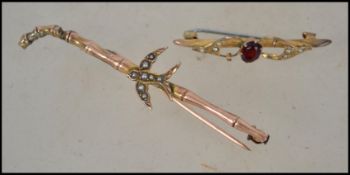 Two early 20th century brooch pins one in the form