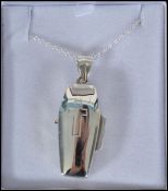 An unusual contemporary ladies silver locket in th