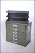 A mid century military green table top filing cabi