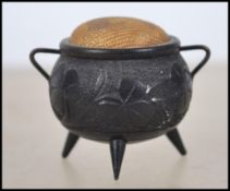 A stunning 19th century bog oak pin cushion in the