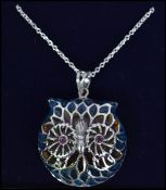 A silver and plique a jour pendant necklace in the