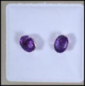 A pair of ladies silver and amethyst ear studs / e
