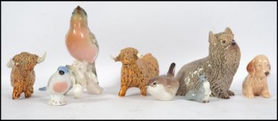 A collection of ceramic animal figurines to includ