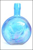 A vintage mid century American carnival glass bottle featuring JFK made by The Wheaton Glass