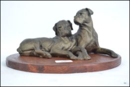 Doris Lindner: A bronzed composition sculpture figure of a two playful boxer dogs. Signed to the