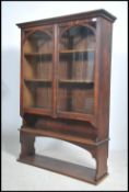 An early 20th century oak display cabinet having t