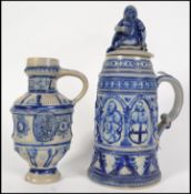 A large early 20th century continental salt glazed German Stein of tall form moulded in relief