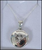 A silver locket and necklace chain with the locket