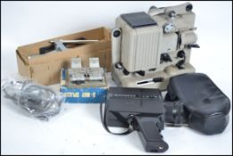 A vintage 8mm film projector together with splicer