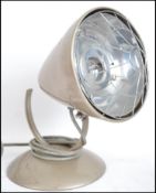 A retro mid 20th century heat lamp, having a circu