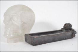 An unusual pressed frosted glass skull together wi
