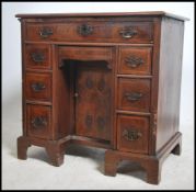 An 18th century Queen Anne walnut kneehole desk of